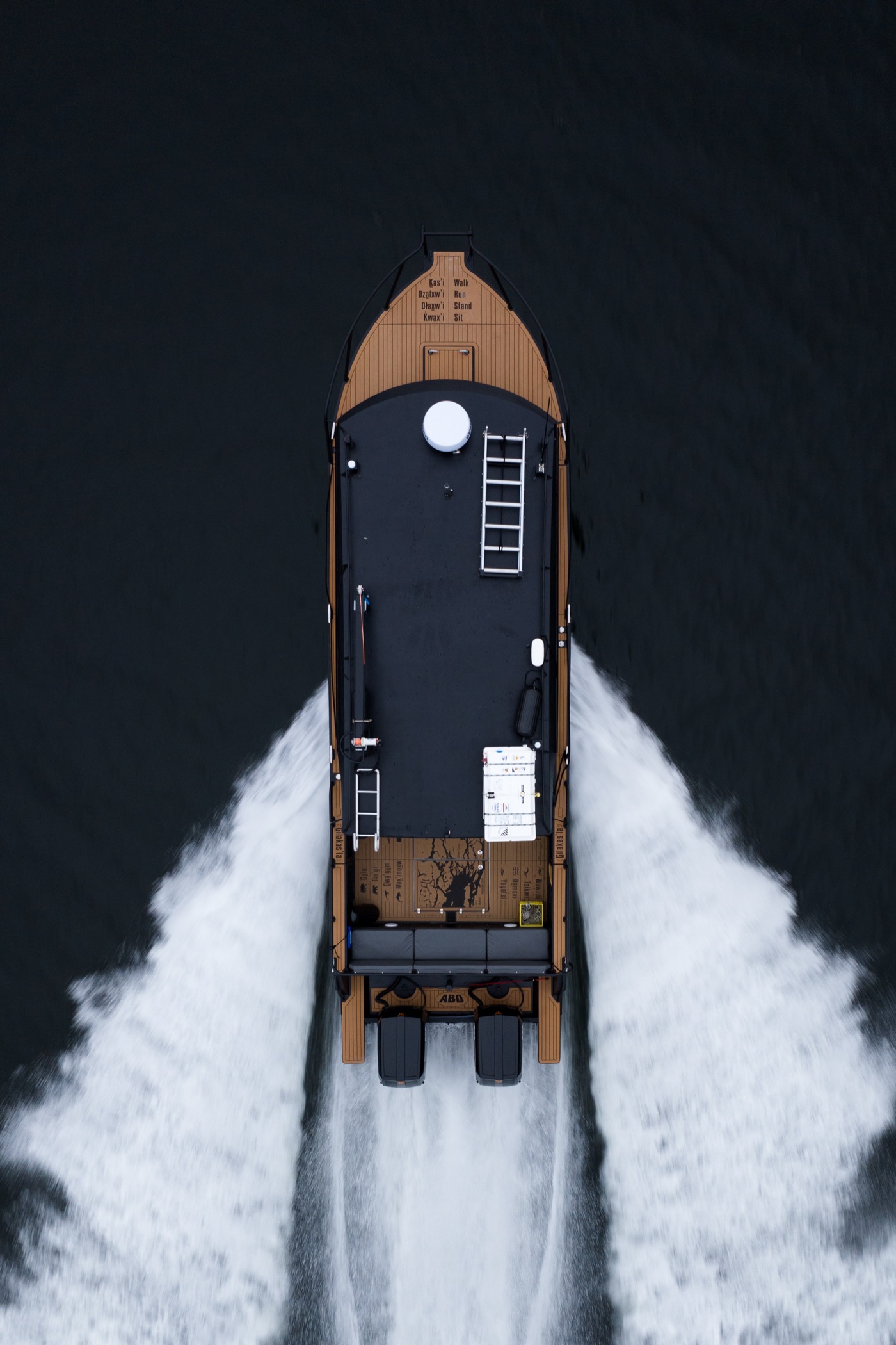 Aerial view of Sea Wolf vessel on Northern Vancouver Island coastal waters with dense forest backdrop, Indigenous entrepreneur-led wildlife tours BC