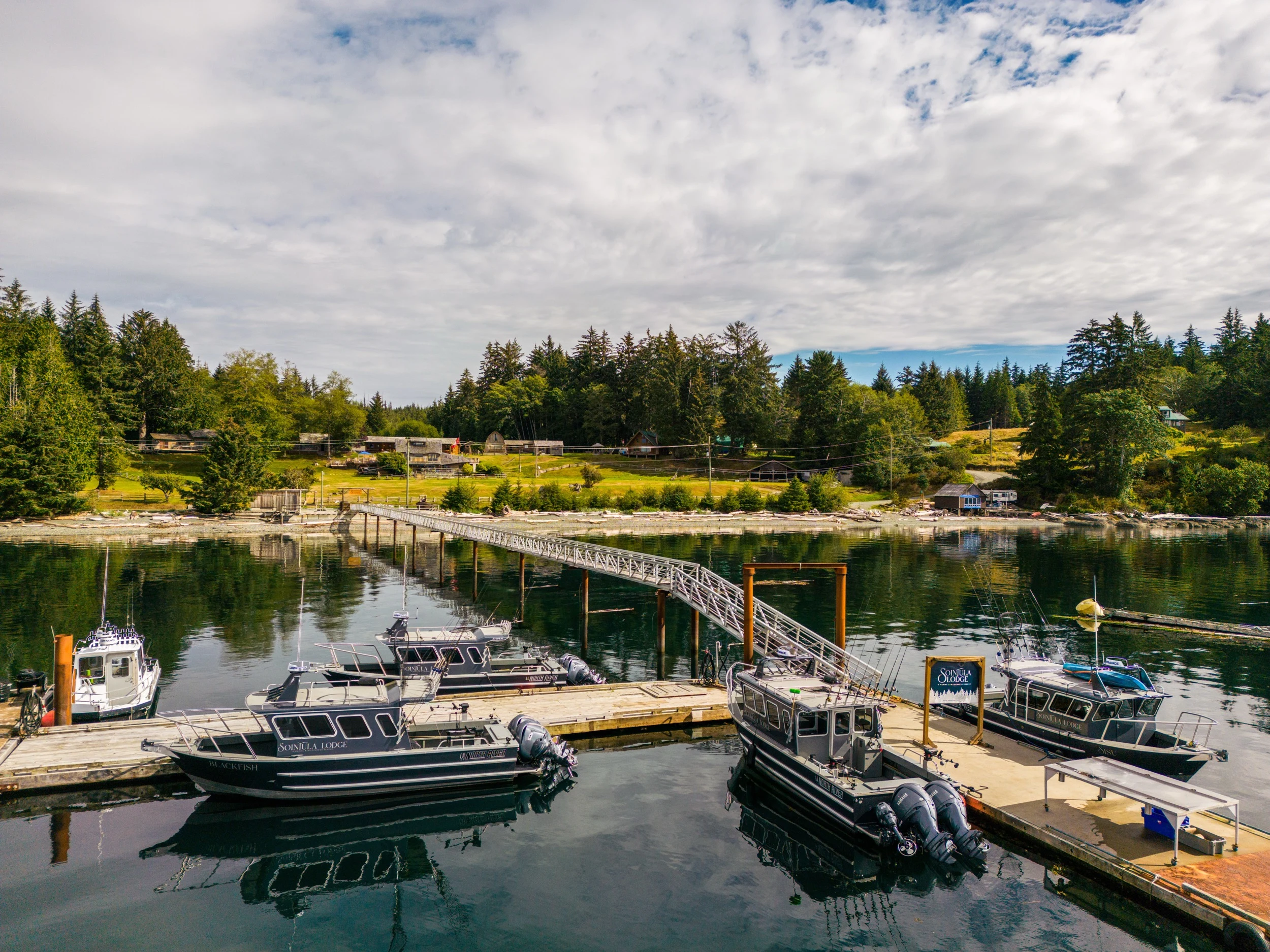 Sea Wolf Lodge dock and marina, boats moored at the waterfront, Kwakwaka'wakw Territory, Northern Vancouver Island