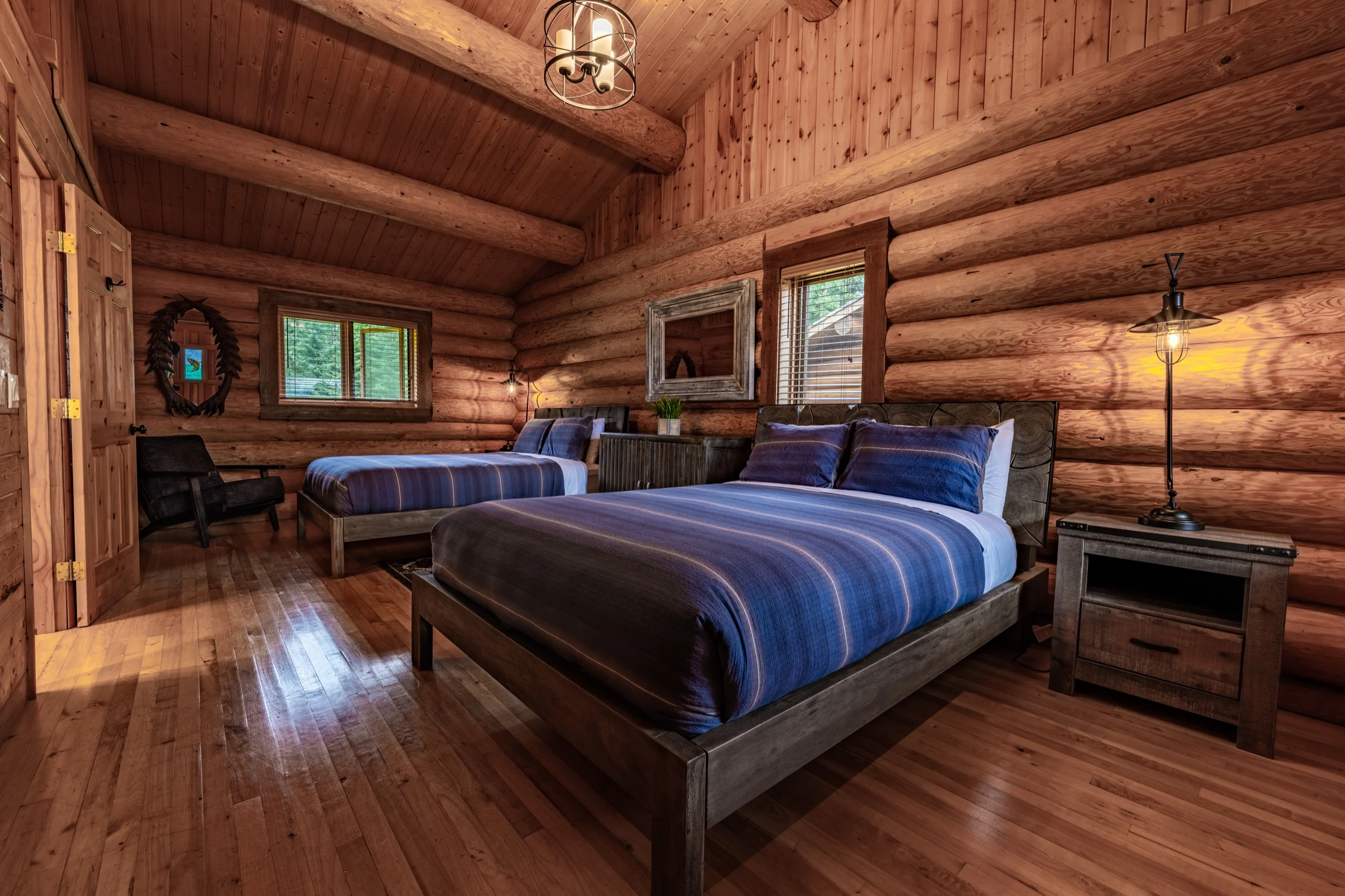 Spacious log-cabin bedroom with two beds at Sea Wolf Lodge