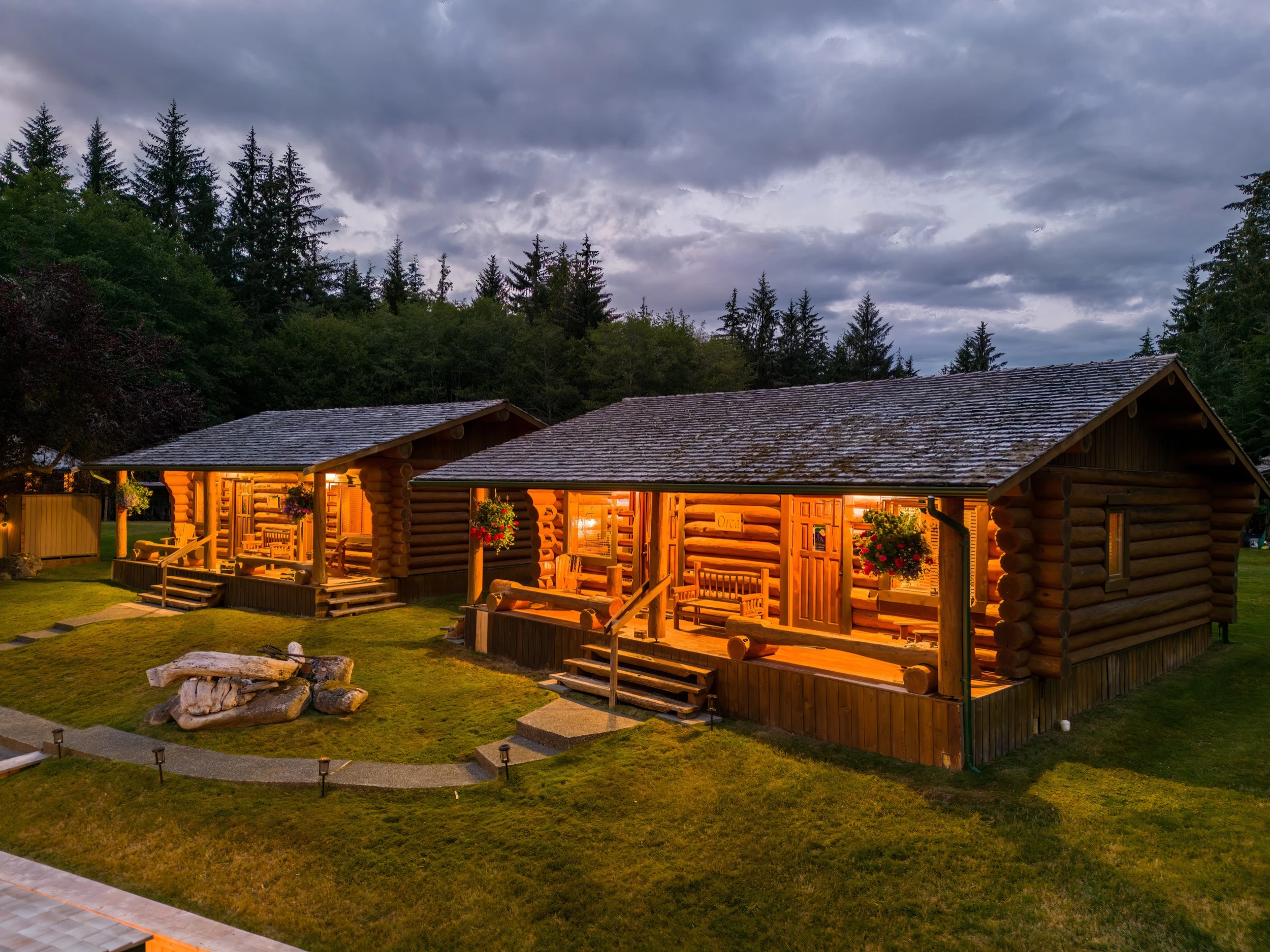 Sea Wolf Lodge outdoor lounge deck with fire feature at twilight, wilderness lodge BC