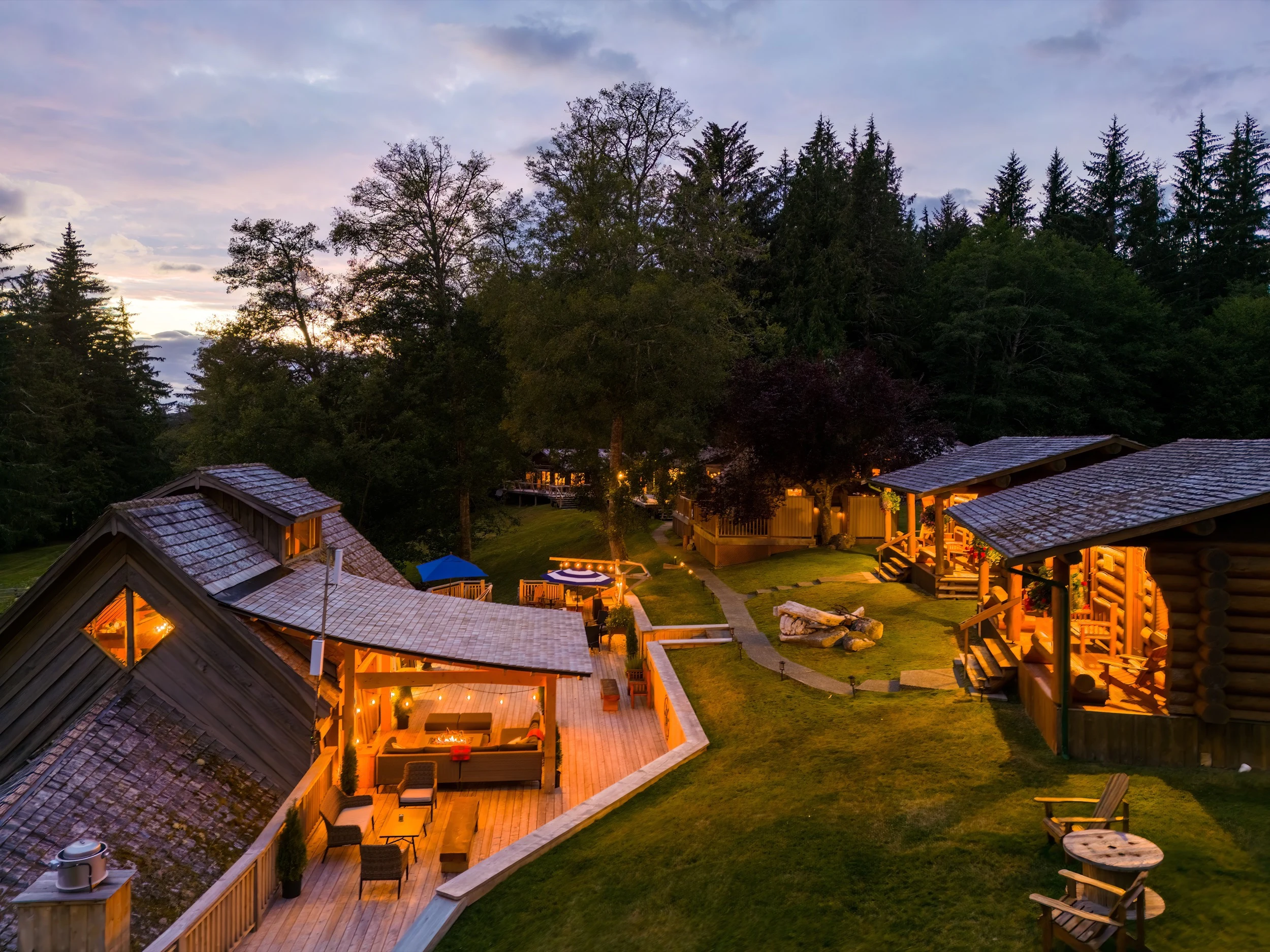 Log cabin glowing at dusk, Sea Wolf Lodge Kwakwaka'wakw Territory, Northern Vancouver Island